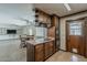 Cozy kitchen featuring dark wood cabinets, tile floors, and plenty of counter space at 2432 W Echo Ln, Phoenix, AZ 85021