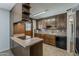 Spacious kitchen with functional island, wood cabinets, and modern appliances at 2432 W Echo Ln, Phoenix, AZ 85021