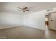 Spacious living room with neutral tile flooring, a ceiling fan, and ample natural light at 2432 W Echo Ln, Phoenix, AZ 85021