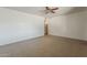 Neutral living room featuring tile floors and a ceiling fan, offering a blank canvas for personalization at 2432 W Echo Ln, Phoenix, AZ 85021