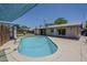 Backyard pool with a diving board, grass and landscaped area at 2432 W Echo Ln, Phoenix, AZ 85021