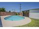 Backyard pool with a diving board, a grass and landscaped area with a privacy wall at 2432 W Echo Ln, Phoenix, AZ 85021