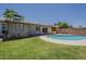 Backyard pool with lush green lawn and covered patio, perfect for outdoor entertaining at 2432 W Echo Ln, Phoenix, AZ 85021