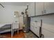 Functional utility room with a sink, cabinets, and water heater, offering convenience at 2432 W Echo Ln, Phoenix, AZ 85021