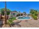 An overview of the backyard featuring a sparkling pool, landscaping, and outdoor seating for relaxing at 2514 E Grand Canyon Dr, Chandler, AZ 85249