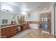 Spacious bathroom features double sinks, granite counters, walk-in shower, and separate soaking tub at 2514 E Grand Canyon Dr, Chandler, AZ 85249