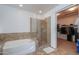 Bathroom with glass enclosed shower, large tub, and walk-in closet access at 2514 E Grand Canyon Dr, Chandler, AZ 85249