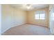 Bright bedroom featuring neutral walls, carpet flooring, ceiling fan and a large window at 2514 E Grand Canyon Dr, Chandler, AZ 85249