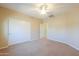 Spacious carpeted bedroom with large closet and ceiling fan at 2514 E Grand Canyon Dr, Chandler, AZ 85249