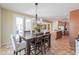 Dining room with modern light fixture, access to kitchen and backyard patio at 2514 E Grand Canyon Dr, Chandler, AZ 85249