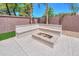 Backyard fire pit with built-in seating, great for entertaining guests at 2514 E Grand Canyon Dr, Chandler, AZ 85249