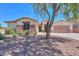 Charming single-story home with stone accents, desert landscaping, and a mature tree in the yard at 2514 E Grand Canyon Dr, Chandler, AZ 85249