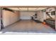 An empty garage with epoxy flooring, storage cabinets, and organizational tools for ultimate convenience at 2514 E Grand Canyon Dr, Chandler, AZ 85249