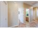 Hallway featuring tiled floors, neutral paint, and views of the bathroom and another bedroom at 2514 E Grand Canyon Dr, Chandler, AZ 85249