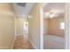 Hallway view featuring tiled floors and neutral paint leading to bedroom with ceiling fan and natural light at 2514 E Grand Canyon Dr, Chandler, AZ 85249