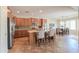 Well-lit kitchen with stainless steel appliances, a tiled backsplash, and an island with bar seating at 2514 E Grand Canyon Dr, Chandler, AZ 85249