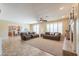 Spacious living room with a fireplace, ceiling fan, and sliding glass doors to the backyard at 2514 E Grand Canyon Dr, Chandler, AZ 85249