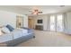Carpeted main bedroom with ceiling fan, curtains, and access to the bathroom and backyard at 2514 E Grand Canyon Dr, Chandler, AZ 85249
