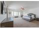 Spacious main bedroom with plush carpet, ceiling fan, and plantation shutters allowing natural light at 2514 E Grand Canyon Dr, Chandler, AZ 85249