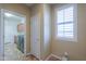Mud Room features tiled flooring, a window, and leads to a laundry room equipped with modern appliances at 2514 E Grand Canyon Dr, Chandler, AZ 85249