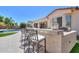 Well-equipped outdoor kitchen with bar seating and stone counter near pool at 2514 E Grand Canyon Dr, Chandler, AZ 85249