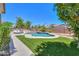 A refreshing pool surrounded by lush landscaping, backyard furniture and artificial grass, perfect for outdoor living at 2514 E Grand Canyon Dr, Chandler, AZ 85249