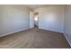 Inviting bedroom with neutral carpet and an open doorway, creating a warm and accessible space at 25748 W Siesta Way, Buckeye, AZ 85326
