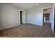 Spacious bedroom with neutral walls and carpet, complemented by two doorways, providing a versatile and serene living space at 25748 W Siesta Way, Buckeye, AZ 85326