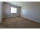 Bright bedroom with a window and neutral carpet, creating a peaceful and inviting atmosphere at 25748 W Siesta Way, Buckeye, AZ 85326