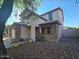 Charming two-story home featuring a stone facade, inviting entrance, and well-maintained desert landscaping at 25748 W Siesta Way, Buckeye, AZ 85326