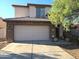 Charming two-story home with a stone-accented facade and well-maintained desert landscaping at 25748 W Siesta Way, Buckeye, AZ 85326