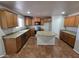 Well-appointed kitchen featuring custom cabinets, stainless steel appliances, and center island at 25748 W Siesta Way, Buckeye, AZ 85326