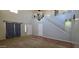 Spacious living room featuring high ceilings, a chandelier, and staircase at 25748 W Siesta Way, Buckeye, AZ 85326