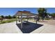 Community picnic area with shaded seating and playground in a well-maintained park setting at 25748 W Siesta Way, Buckeye, AZ 85326