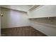 Large walk-in closet featuring multiple levels of shelving, perfect for organizing and storing clothing and accessories at 25748 W Siesta Way, Buckeye, AZ 85326