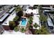 Aerial view of the complex featuring the pool, manicured landscaping, and surrounding residential buildings at 2625 E Indian School Rd # 206, Phoenix, AZ 85016