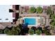 Overhead shot of the pool and common area showing the pool, lounge chairs, trees, and surrounding buildings at 2625 E Indian School Rd # 206, Phoenix, AZ 85016