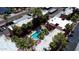 Aerial view of the complex featuring the pool, manicured landscaping, and surrounding residential buildings at 2625 E Indian School Rd # 206, Phoenix, AZ 85016