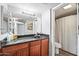 Cozy bathroom with a granite sink, wood cabinets, and a shower/tub combo at 2625 E Indian School Rd # 206, Phoenix, AZ 85016