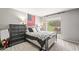 Bedroom featuring neutral walls, carpet, and a window at 2625 E Indian School Rd # 206, Phoenix, AZ 85016