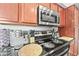 Close up shot of updated black granite countertops and stainless appliances in kitchen at 2625 E Indian School Rd # 206, Phoenix, AZ 85016
