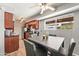 Eat-in kitchen with stainless steel appliances, grey walls, wood cabinets, and a ceiling fan at 2625 E Indian School Rd # 206, Phoenix, AZ 85016