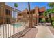 Enclosed community pool with wrought iron fence, offering privacy and safety for residents at 2625 E Indian School Rd # 206, Phoenix, AZ 85016