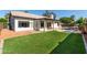 Landscaped backyard featuring a lush lawn, covered patio, and sparkling pool at 2716 N Kristen --, Mesa, AZ 85213