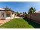 Sprawling backyard features a covered patio, lush lawn, and sparkling pool at 2716 N Kristen --, Mesa, AZ 85213
