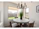 Bright breakfast nook features a modern chandelier and a large window overlooking the backyard at 2716 N Kristen --, Mesa, AZ 85213