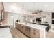 Modern kitchen with stainless steel appliances, a large island, and a view of the living room at 2716 N Kristen --, Mesa, AZ 85213