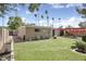 Spacious backyard with lush green lawn, red pergola, and potential for outdoor activities at 3018 E Mulberry Dr, Phoenix, AZ 85016