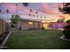 Lush backyard featuring a covered patio, manicured lawn, and perimeter landscaping at 3018 E Mulberry Dr, Phoenix, AZ 85016