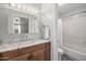 Bathroom showcasing a stylish vanity with marble countertop and an attached bathtub with shower at 3018 E Mulberry Dr, Phoenix, AZ 85016